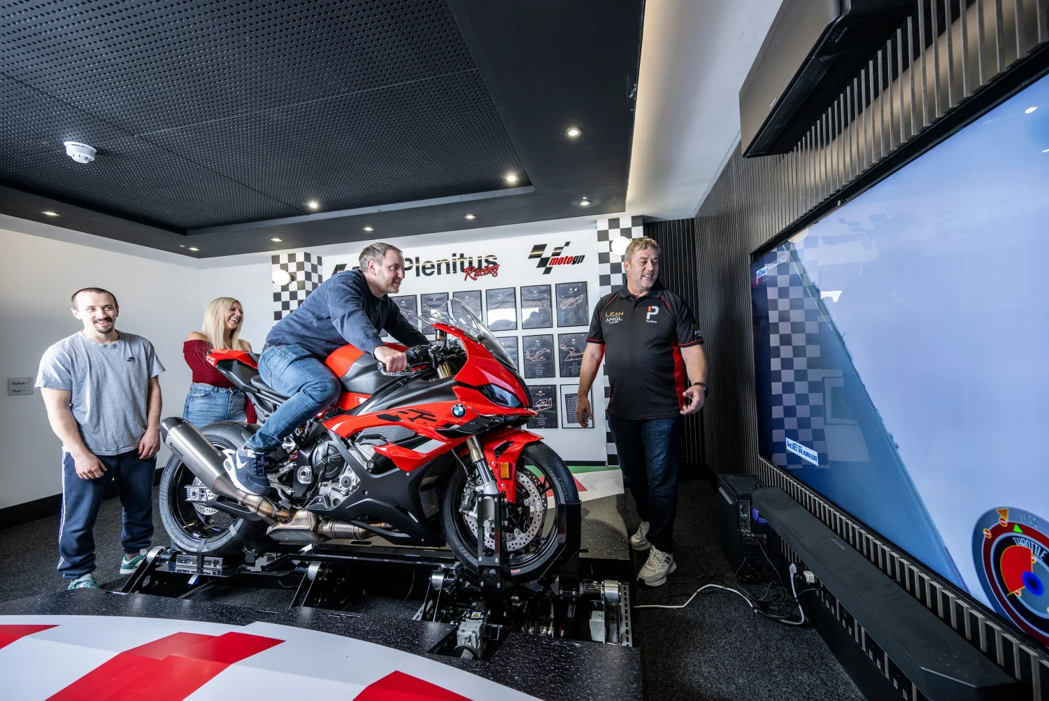 Group enjoying a guided riding session on the Plenitus Racing Sim