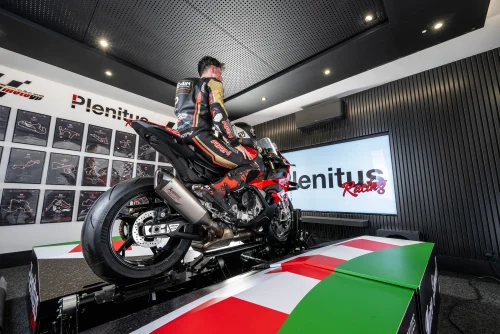 Professional rider training on the Plenitus Racing Sim inside the circuit analysis room