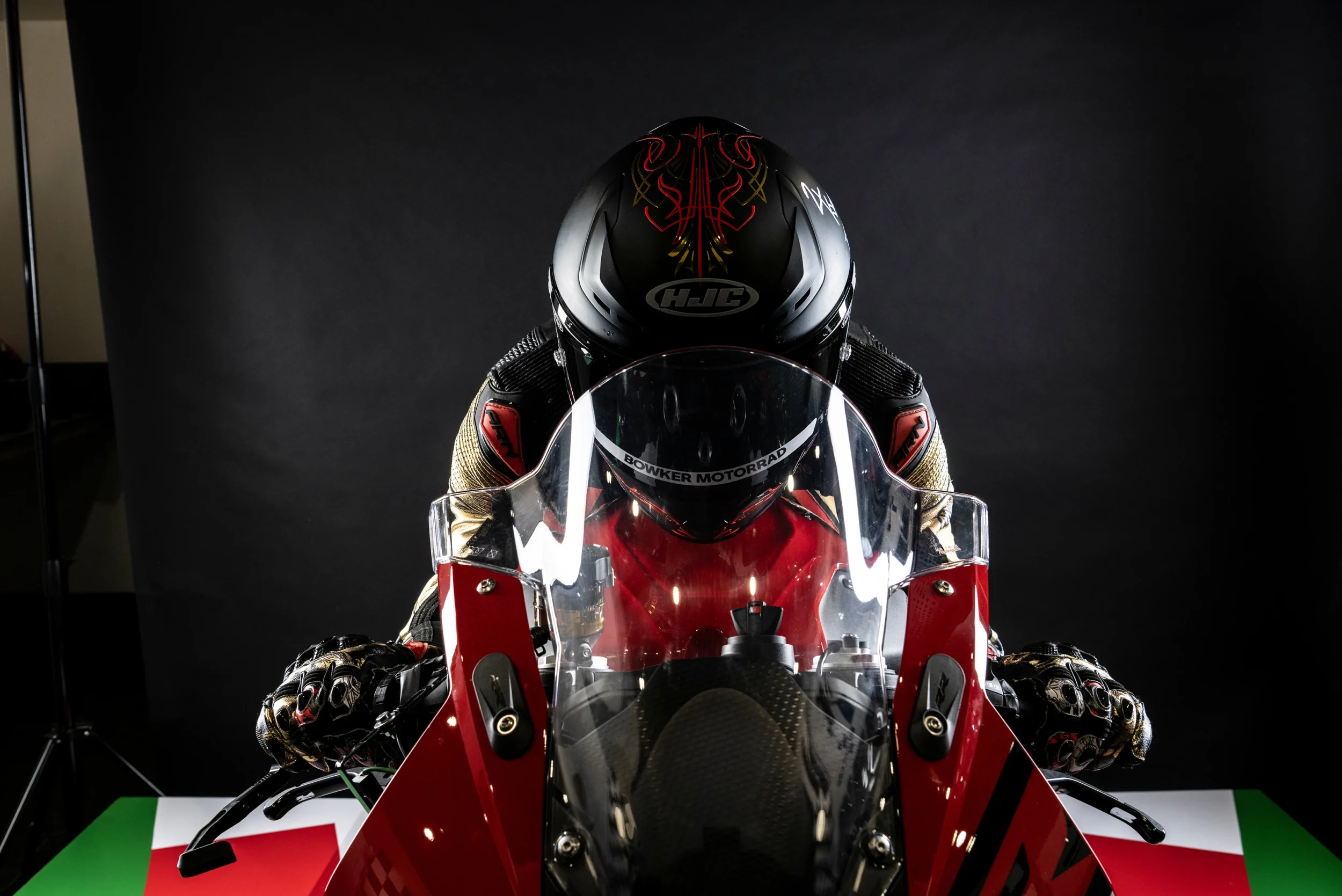 Professional rider in full race position on the Plenitus Racing Sim